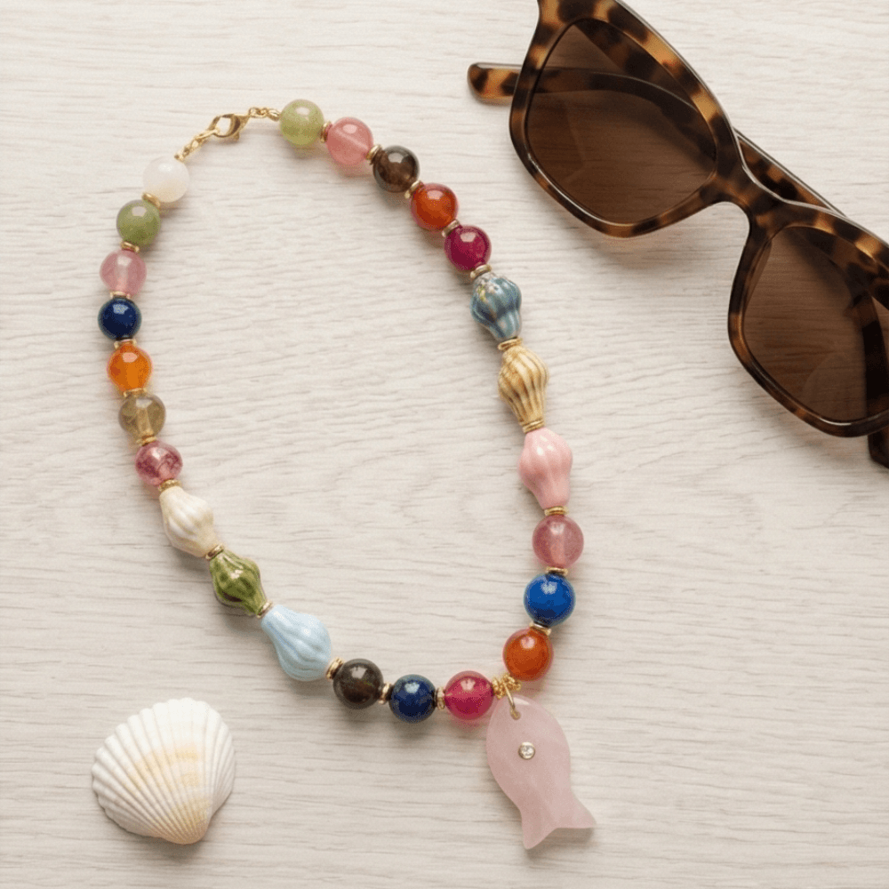 Colorful summer necklace with fish pendant styled with sunglasses beach aesthetic