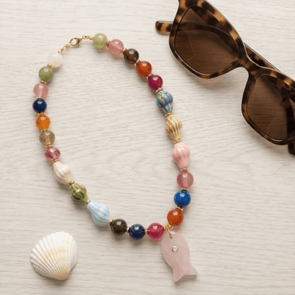 Colorful summer necklace with fish pendant styled with sunglasses beach aesthetic