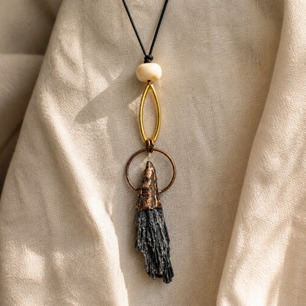 Terra adjustable long pendant necklace in ivory with copper-tone and dark stone-like handcrafted pendant