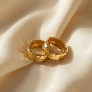 textured gold hoop earrings hammered finish minimalist jewelry flat lay