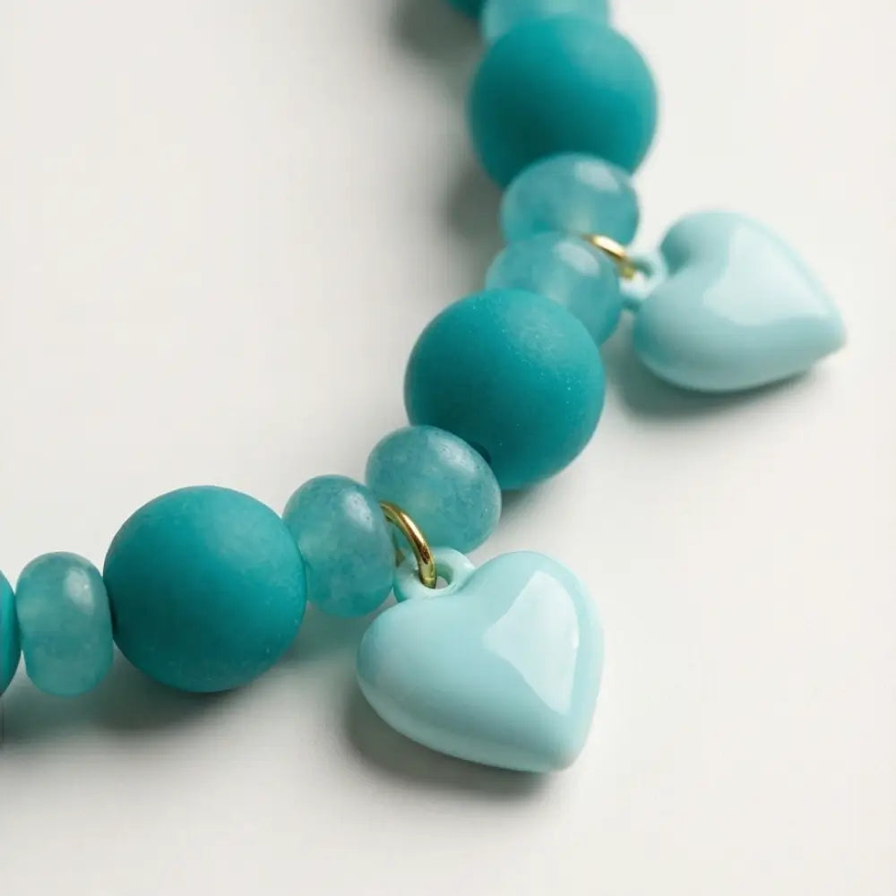 close up turquoise beaded necklace with heart charms detail waterproof design
