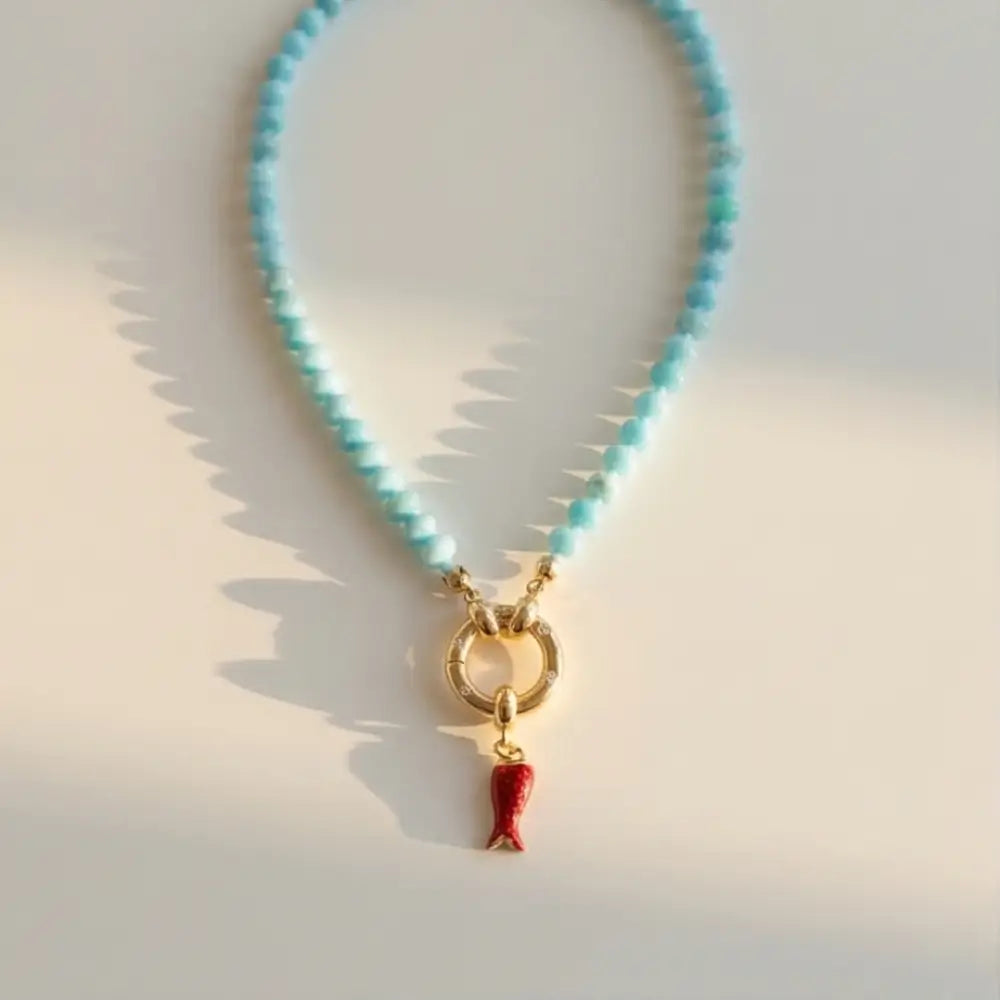 turquoise beaded necklace with gold clasp and red charm minimal jewelry Julie Saldivia
