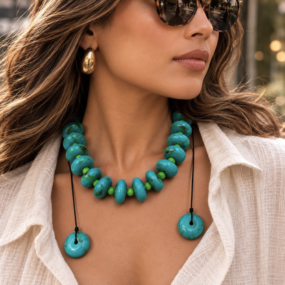 Close-up of woman wearing Turquoise Lime adjustable statement necklace with 15 mm turquoise-tone acrylic beads, 8 mm lime green accents and black cord