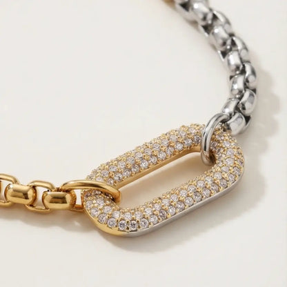 Close-up of two-tone gold and silver chain necklace with pavé diamond clasp detail luxury jewelry